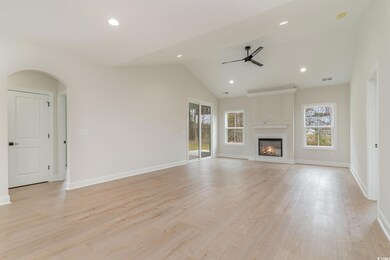 Unfurnished living room featuring arched walkways,