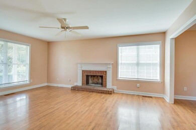 Beautiful living room with so much natural light and a fireplace. 