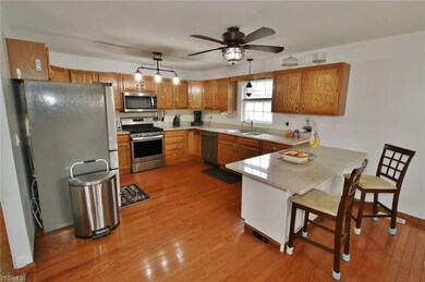 Spacious kitchen with hardwood floors and granite countertop