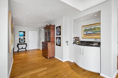 The spacious entry features a curved wet bar with