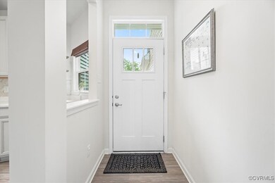 Entryway featuring wood finished floors and basebo