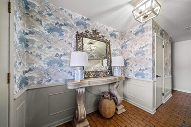 Office space with a wainscoted wall, wallpapered w