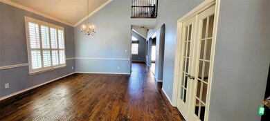 Unfurnished dining area with a notable chandelier, dark hardwood / wood-style flooring, and ornamental molding