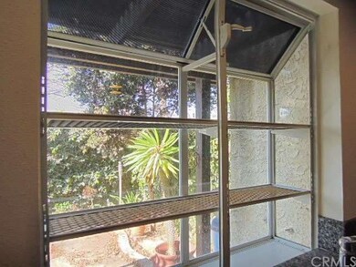 Kitchen garden window looks out to private patio yard.
