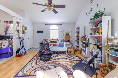 Office with a ceiling fan, wood finished floors, and lofted ceiling