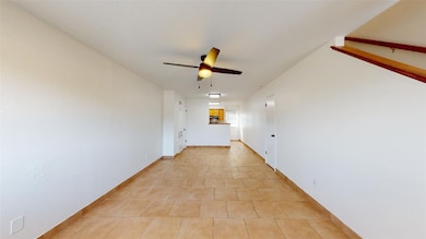 Hall with baseboards and light tile patterned floo