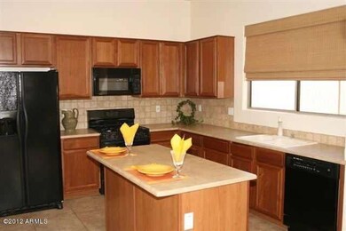 Maple Cabinets w/travertine backsplash