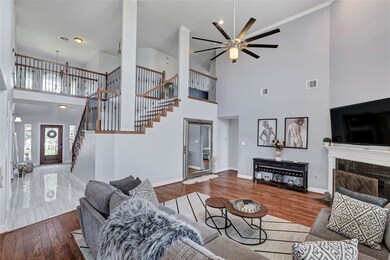Staged-Natural light floods into this expansive living area. The exposed stairway adds to the open feel.