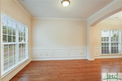 Formal Living room with wains coating, crown moldi