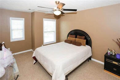 Carpeted bedroom with baseboards and ceiling fan