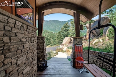 Covered front patio with custom ski lift chair seat (from Angel Fire Resort)!
