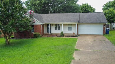 Ranch-style home featuring driveway, a porch, an attached garage, a front yard, and brick siding