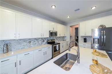 Kitchen featuring white cabinetry, visible vents, 