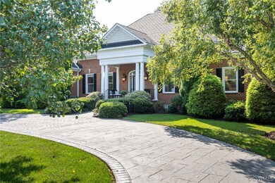 Beautiful circular driveway wraps the front landsc