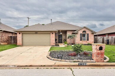 Single story home featuring driveway, a garage, brick siding, and roof with shingles