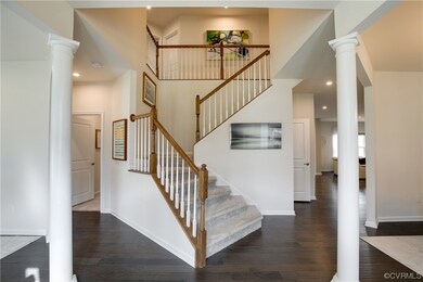 Staircase with dark hardwood / wood-style flooring