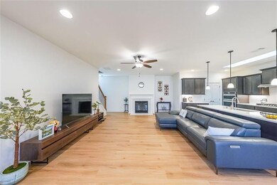 Living area featuring a glass covered fireplace, r
