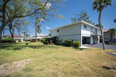 View of property exterior with a lawn, a carport,