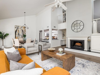Living area featuring vaulted ceiling, a ceiling 