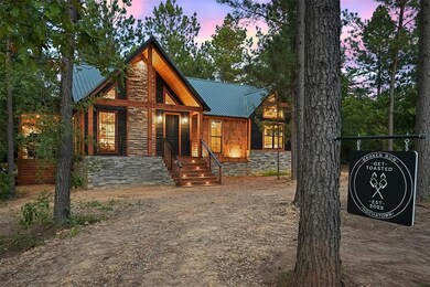 Chalet / cabin with a metal roof and stone siding