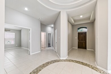 This view shows the entry way, study, and hallway to secondary bedrooms.
