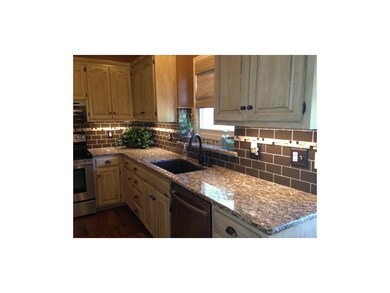 Granite countertops and glass subway tile backspla