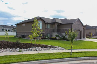 View of front of property featuring brick siding, a garage, and concrete driveway