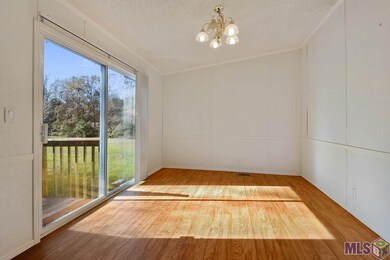 The dining room features a sliding glass door with