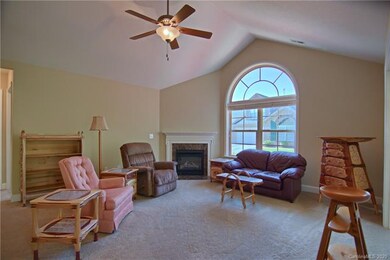 Living room with cathedral ceiling and cozy gas fi
