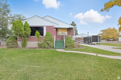 Bungalow-style house featuring a front yard and brick siding