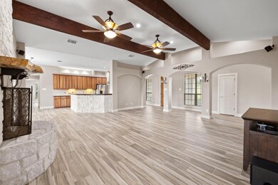 Unfurnished living room with arched walkways, cei