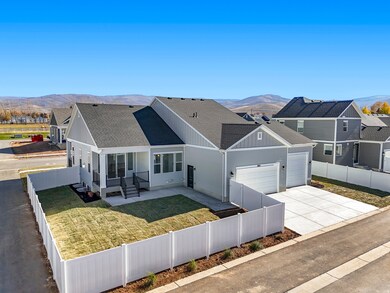 View of front facade with a fenced front yard, roof with shingles, a mountain view, concrete driveway, and an attached garage