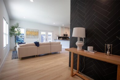 Living room with light hardwood / wood-style floor