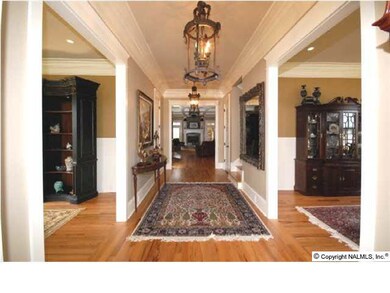 AS YOU ENTER THIS FABULOUS HOME THE 23 X 08 FOYER FEATURES HARDWOOD FLOORS AND CROWN MOLDING.