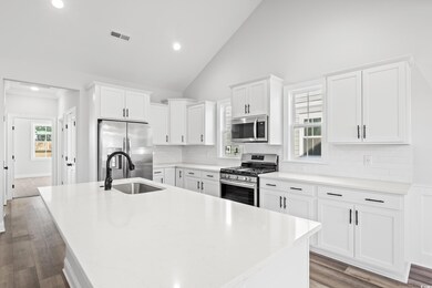 Kitchen featuring a center island with sink, sink,