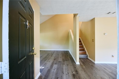 Entrance foyer with wood finished floors, stairway