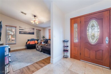 Entryway with visible vents, vaulted ceiling, base