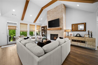 Windows in Living Room Feature Woven Wood Roman Shades