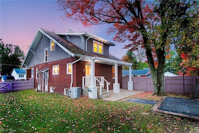 Back house at dusk featuring central AC