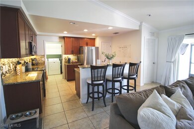 Kitchen featuring washer and clothes dryer, backsp