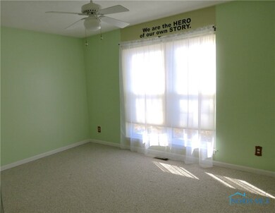 Front bedroom with ceiling fan, double closet.