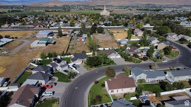 Aerial overview of property's location featuring nearby suburban area and a mountainous background