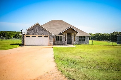 Craftsman inspired home featuring driveway, a garage, brick siding, and a shingled roof