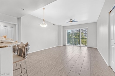 Unfurnished living room featuring a ceiling fan an