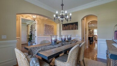 The formal dining room flows naturally into the kitchen and living area.