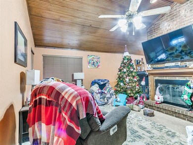 Living room with ceiling fan, wooden ceiling, loft