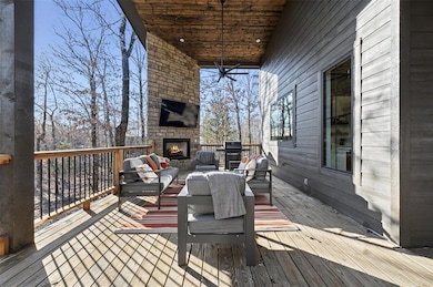 Deck featuring an outdoor living space with a fire