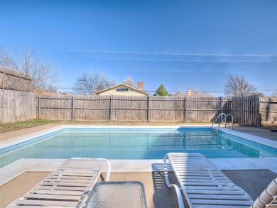 View of pool with a patio area, a fenced backyard,