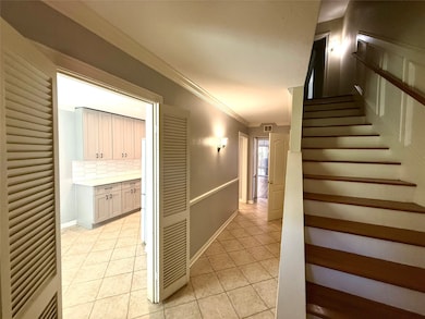 Welcome home to an inviting entryway, featuring elegant tile flooring and easy access to the kitchen and living areas.