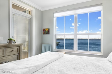 Bedroom featuring a water view and ornamental mold
